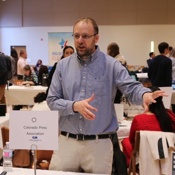 A representative talking with students at the career fair