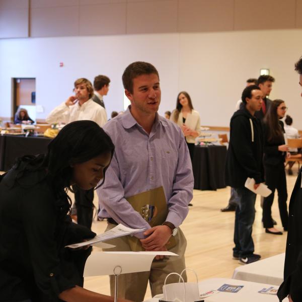 Students talkin with a representative at the career fair