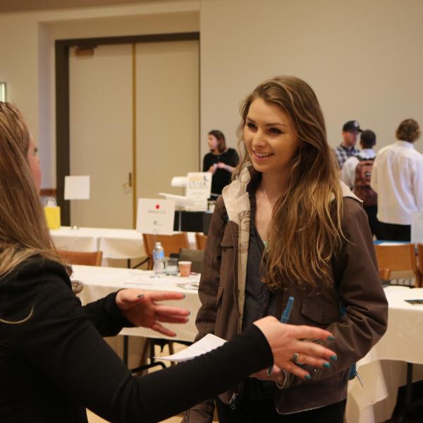Students talking with a representative at the career fair