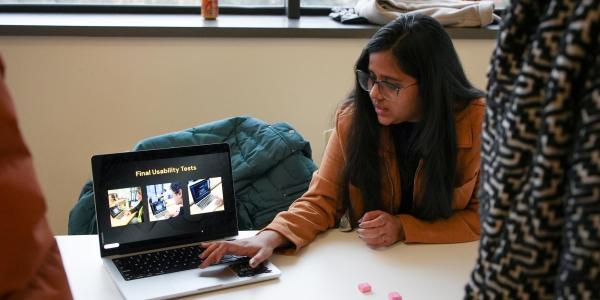 A student shows work on her laptop.