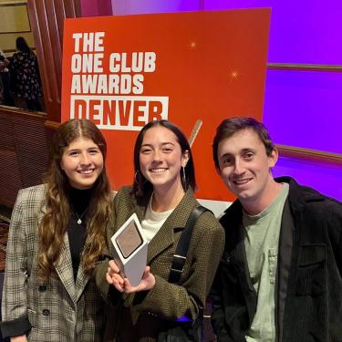 Students Francesca D’Agostino, Parker Jones and Matt Peters (left to right), who are in the creative advertising track of the strategic communication major, show the bronze medal award they earned for their project for Budweiser during the Nov. 11 ceremony.