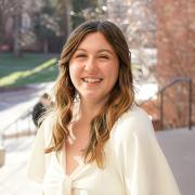 Cassidy Davis smiles while she poses by the CASE building on campus.