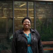 shamika in front of case building