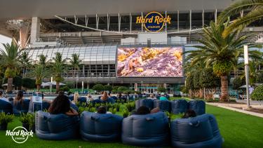 Cars parked inside of Hard Rock Stadium for a drive-in movie. 