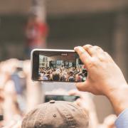 Person taking a picture of a performer.