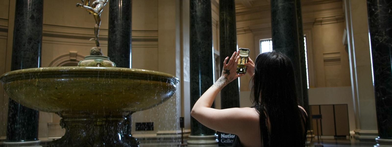 Student takes a picture inside a museum