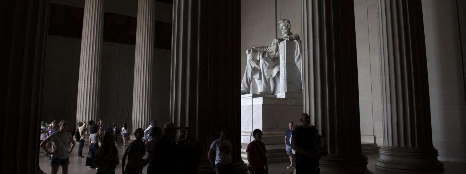 Tourists look up at the Lincoln Memorial in Washington.