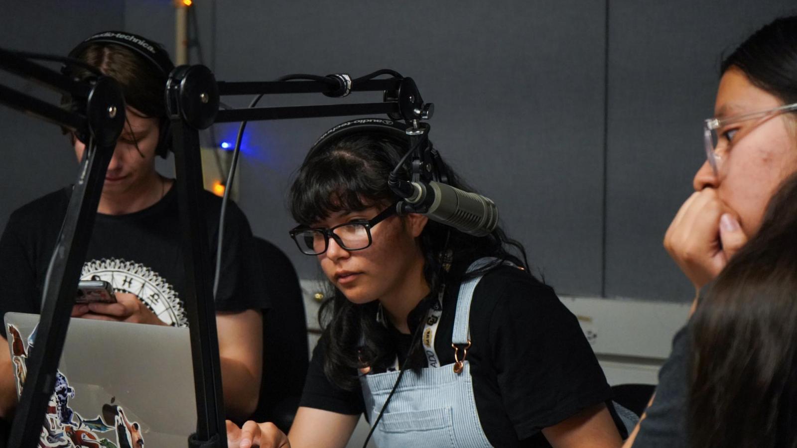Students use a podcast booth
