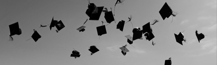 Graduation Caps thrown in air stock image