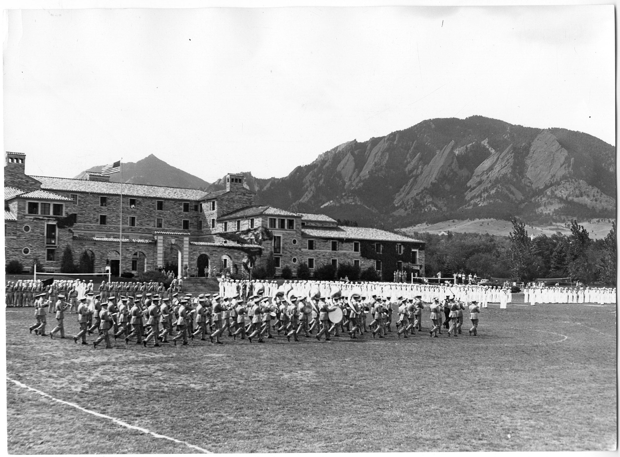vintage photo of military marching band practicing outside of Baker Hall in 1943
