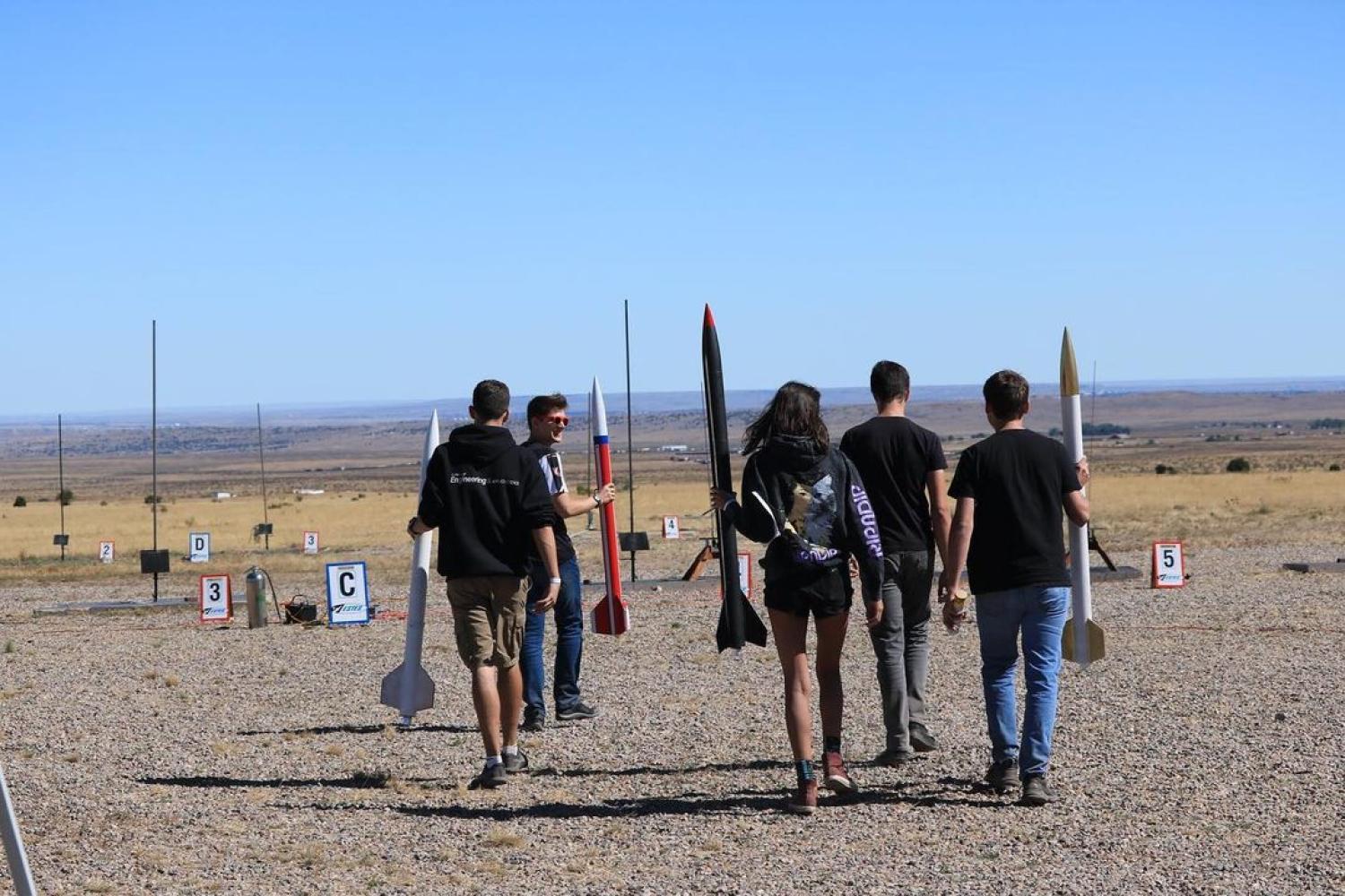 Several Sounding Rocket Lab team members prepare to launch their rockets.