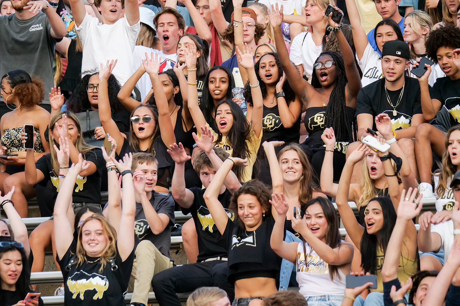 Students cheering on the Buffs during a football game
