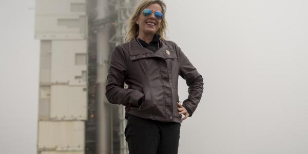 Laurie Cantillo in front of a rocket at NASA