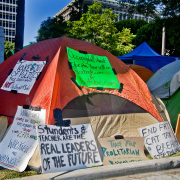 tent in city covered with political posters