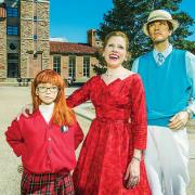 Suzanne Heintz poses with dummy "husband" and "daughter" at the University Memorial Center fountains