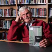 michael radelet posing with his book 