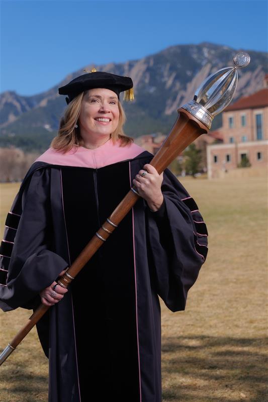 Marshal Leigh Holman holding university mace