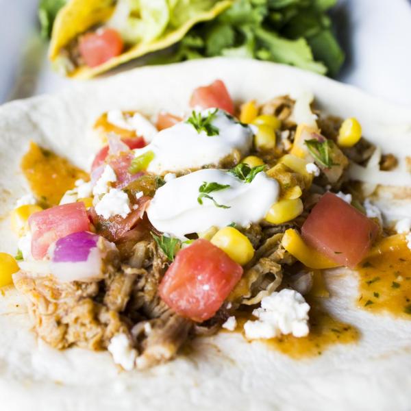 Soft taco with shredded pork, cheese, pico de gallo, crema and cilantro
