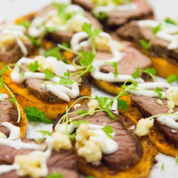 Crostini with thinly sliced beef, horseradish sauce and watercress