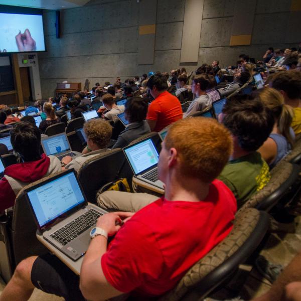 Students listening to lecture and taking notes on laptops