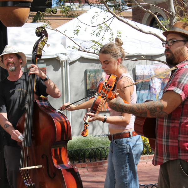 Three musicians playing on Pearl St. Mall
