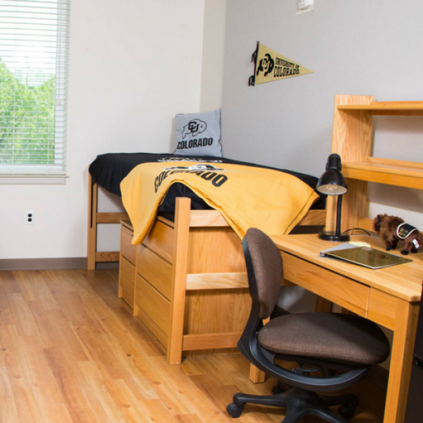 Double res hall room with beds, desks, chairs, window