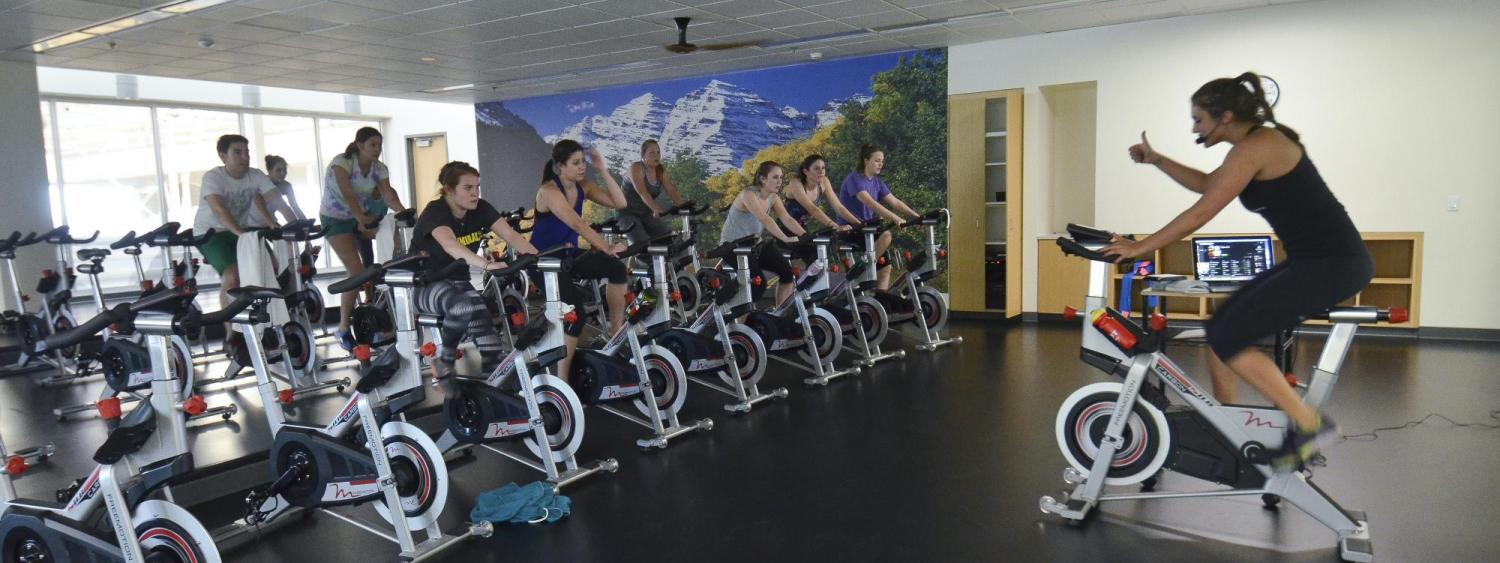 A group of people on stationary bikes