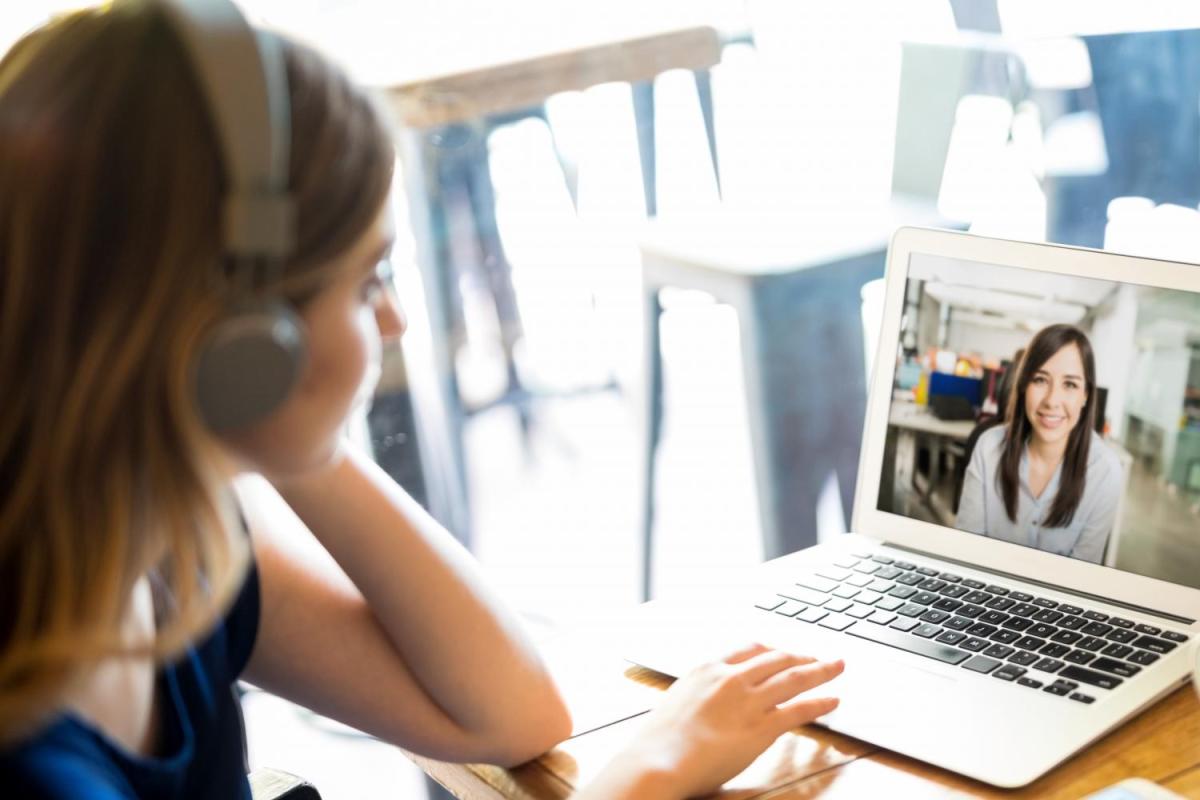 woman on laptop talking to one person