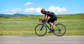 William Luce rides his bike along a rural Boulder road. 