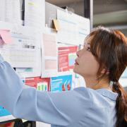 Woman looks at research board