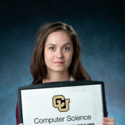 Amy Richards holds a sign celebrating 50 years of the CS department's existence