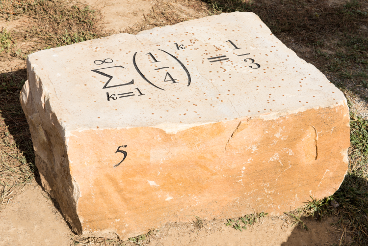 Equation of the sum of the geometric series 1/4, etched on a rock