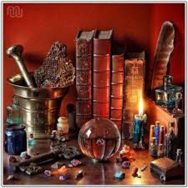 old books, a crystal and a candle - an alchemy workshop 