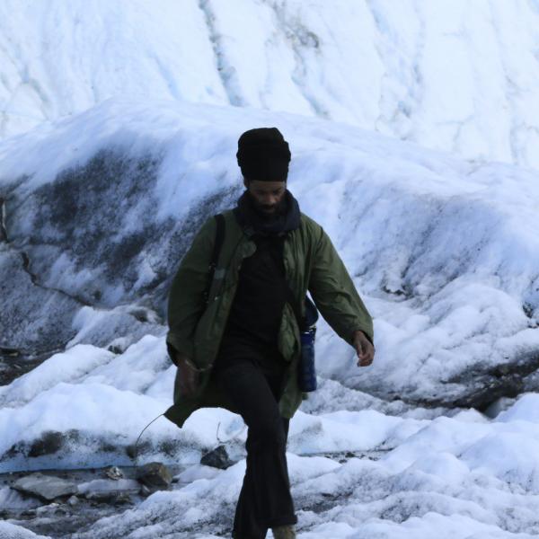 Photo of LaMont Hamilton walking through a snowy landscape.