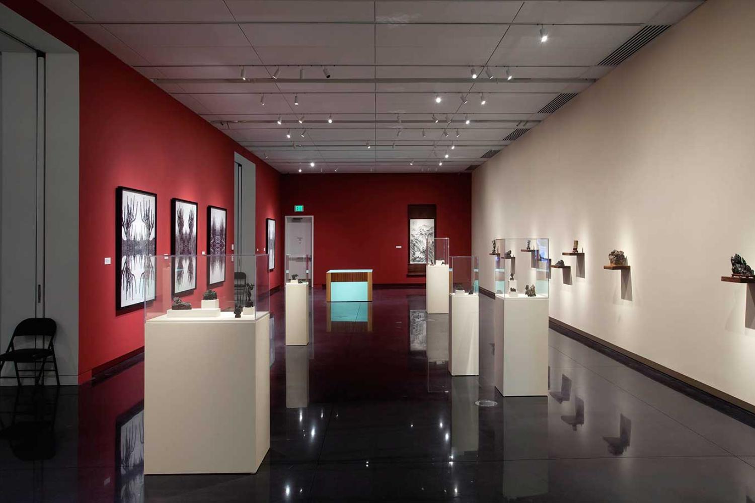 Installation view of exhibition featuring scholar's rocks and hung works