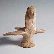 Ceramic figurine of a bird featuring a woman’s face