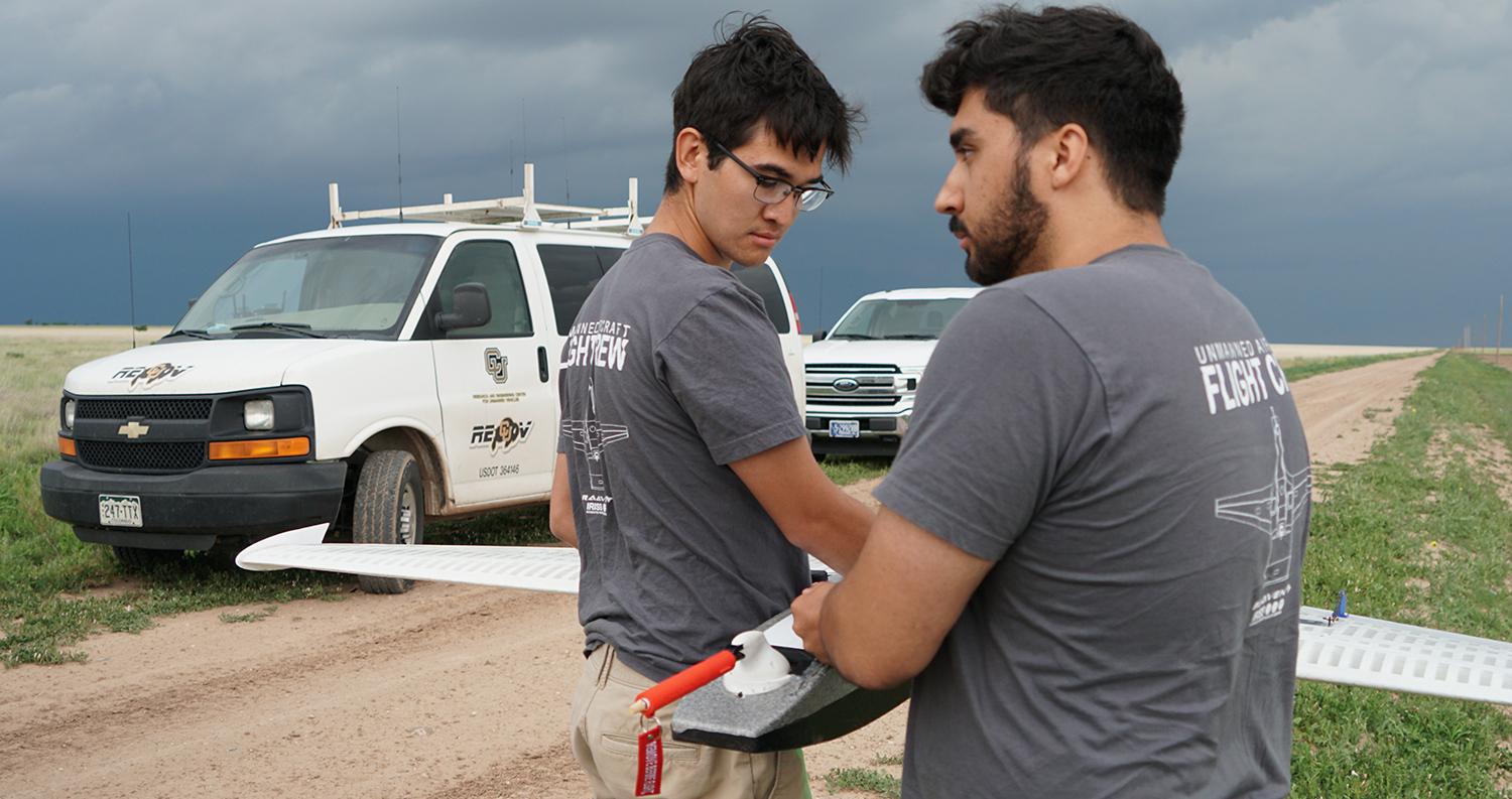 CU Boulder students hold a drone while researching severe weather