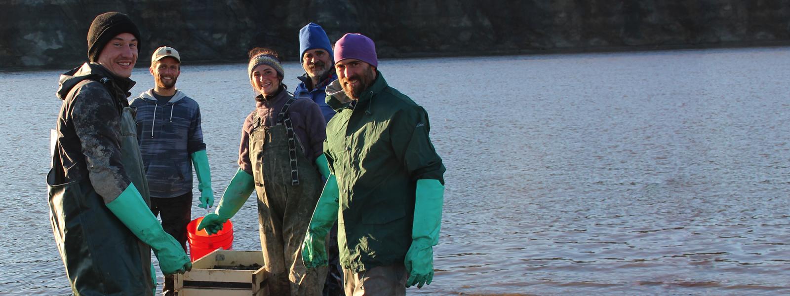 Researchers sifting dirt on the shores of the Alaskan coast