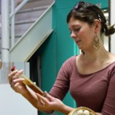 Woman looking at handheld artifact