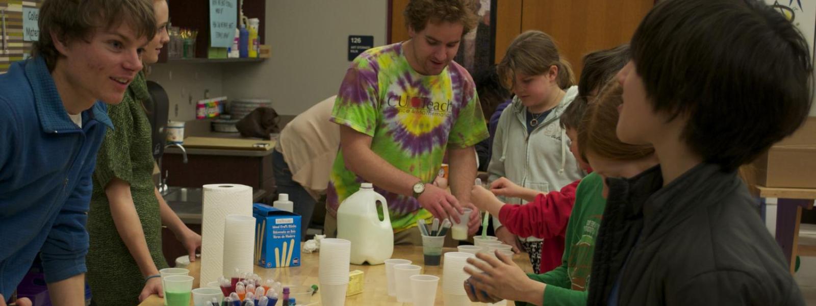 CU Teach students and kids work on tie dye chemistry lesson