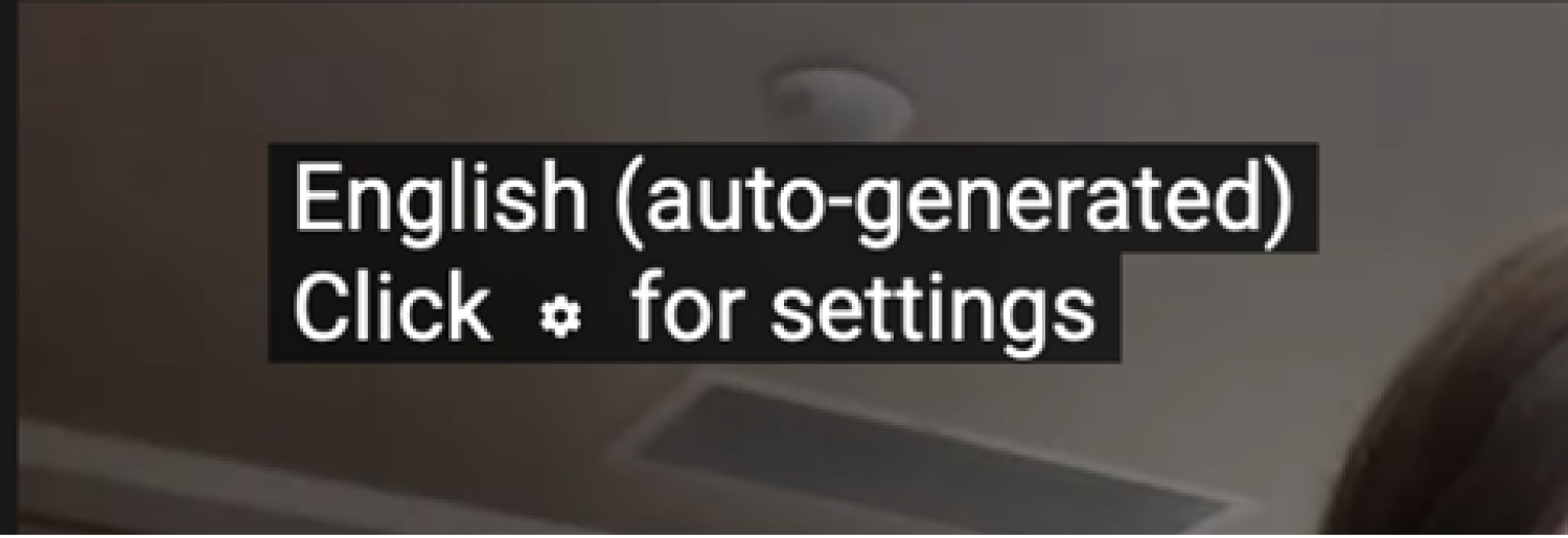YouTube video message that reads "English (auto-generated) Click for settings"