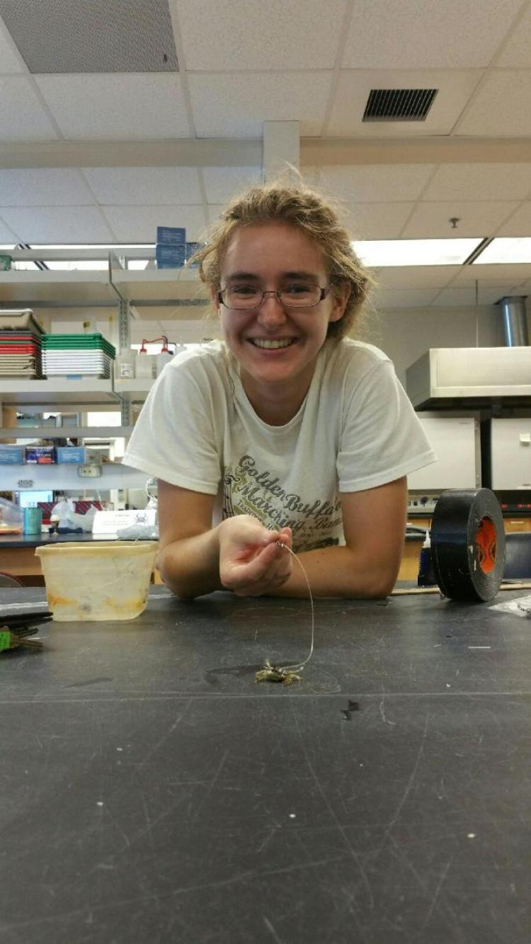 Smith grins over a tethered blue crab.