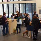 Alumni and students mingle over lunch in the Rustandy Building Olson Atrium