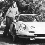 Image of Barbara Jean standing next to sports car coupe