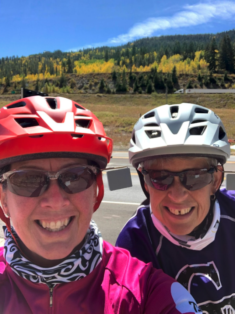 Cindy is on the left pictured with her wife on a cycling trip
