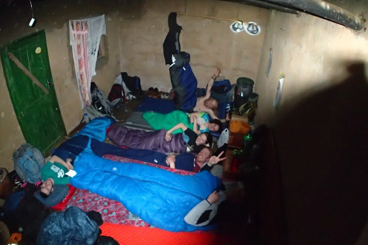 The team members lay in their sleeping bags in the hut where they'll stay during the project.