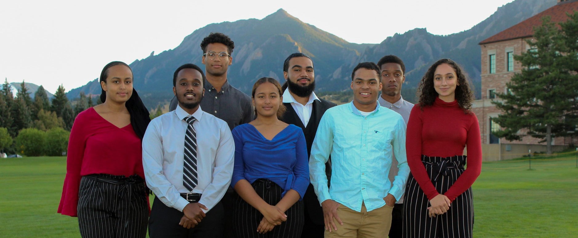 The executive leadership board of the CU Boulder NSBE chapter poses for a group photo on the business field. 