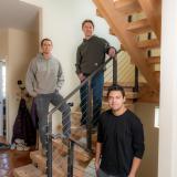 Morris, Kurtz and Donado Quintero stand on a staircase inside the home