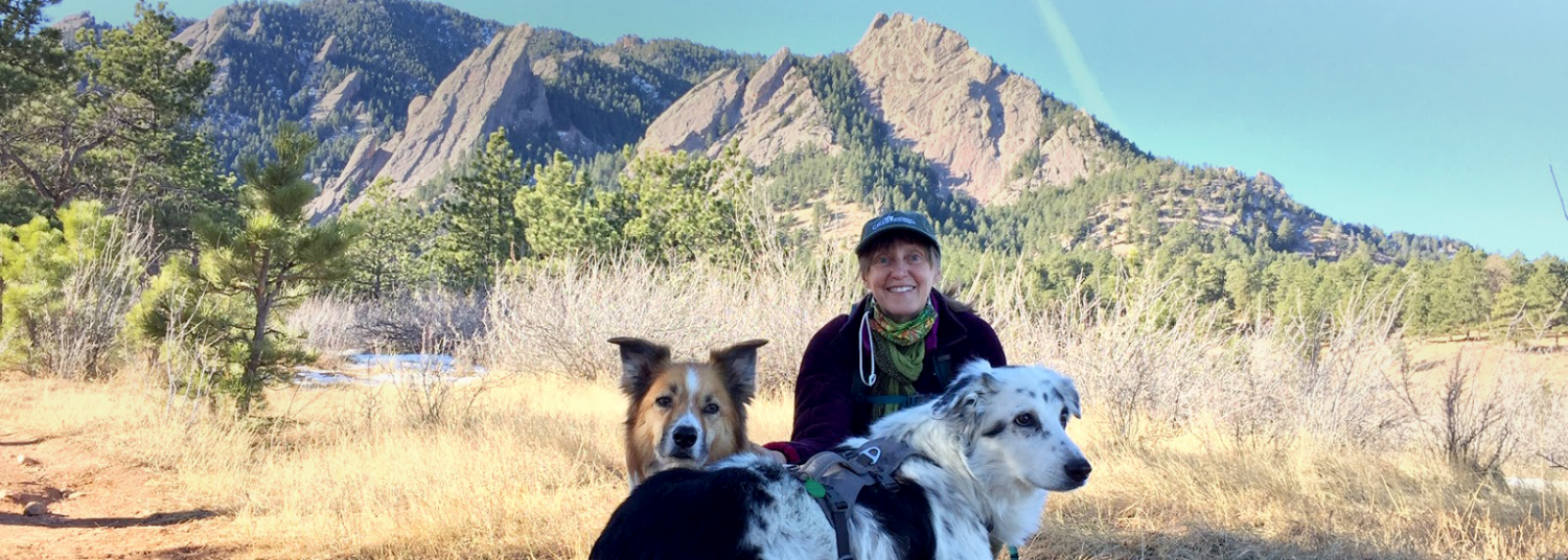 Hope Michelsen and her dogs posing in front of the Flatirons