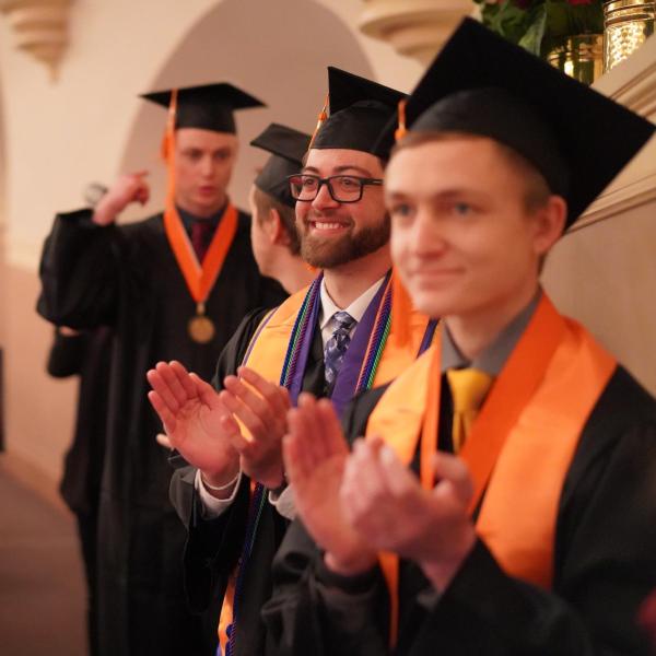 Clapping graduates
